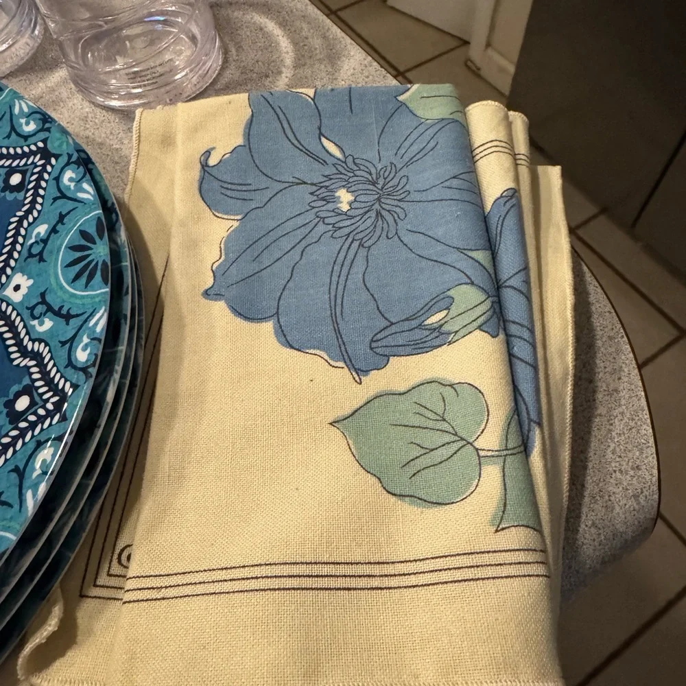 Blue Patterned Plates and Glasses with‎ Floral Napkins